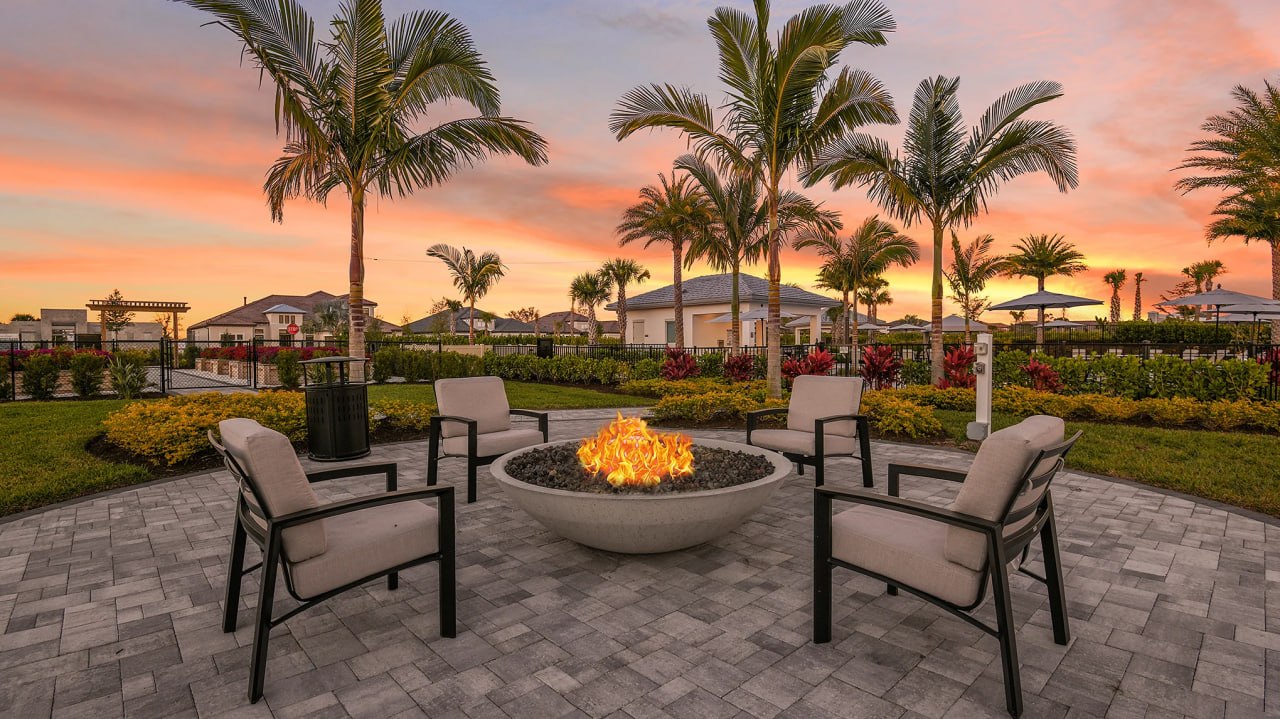 Outdoor fire pit and sunset lifestyle area at Esplanade at Rivergrass in Naples Florida